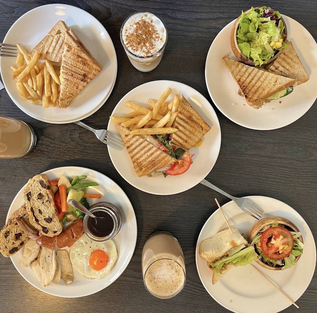 Amigos brunch spread with grilled sandwiches and drinks